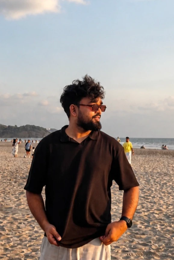 Shushant Kumar on a beach at sunset